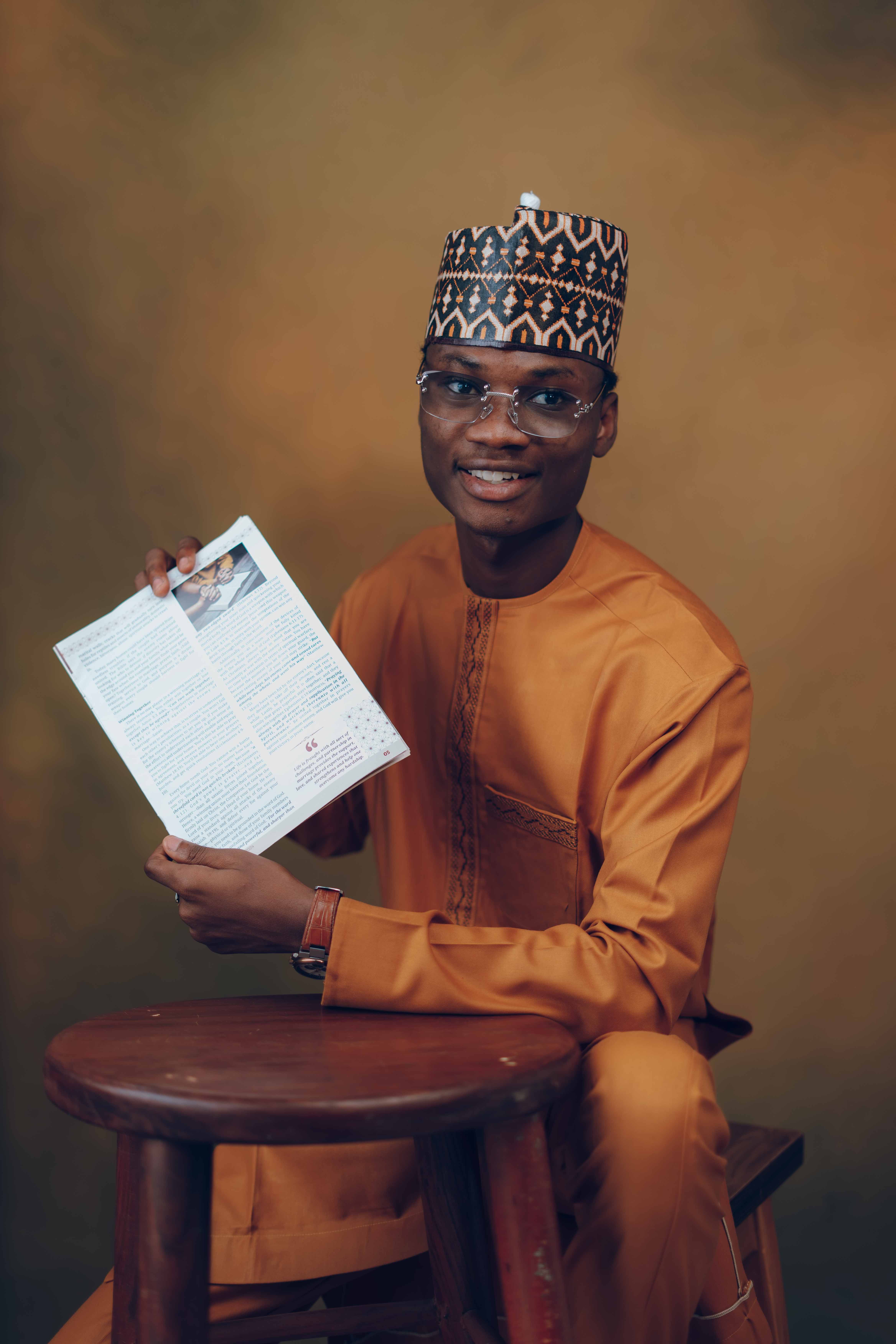 Illustrative image of a Nigerian man holding and reading a document