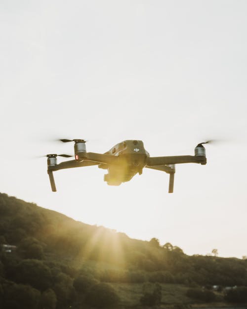 A Black Quadcopter Drone Flying outdoors