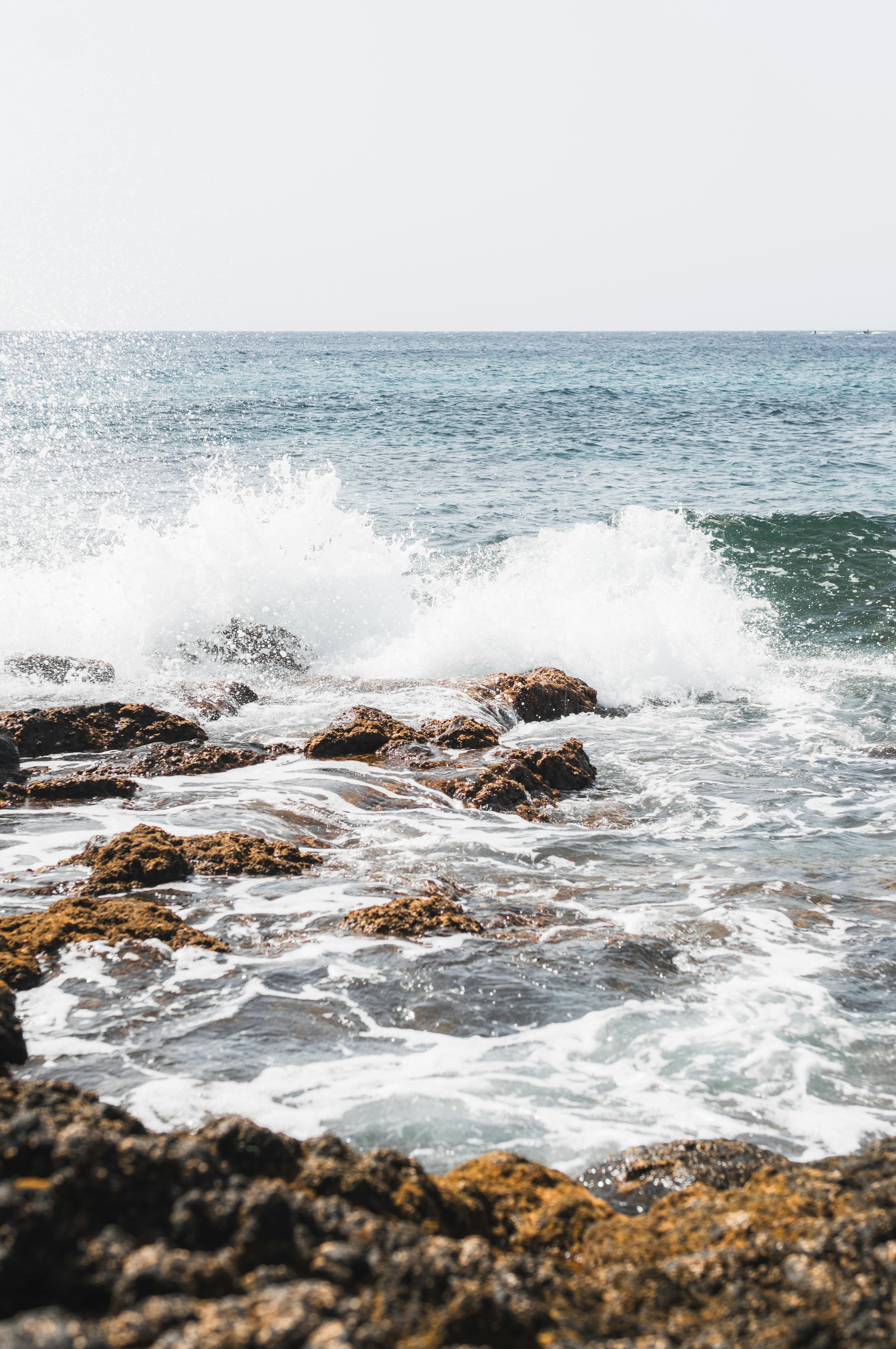 Dynamic waves crash against rocky shores in Lanzarote, capturing nature's raw beauty.