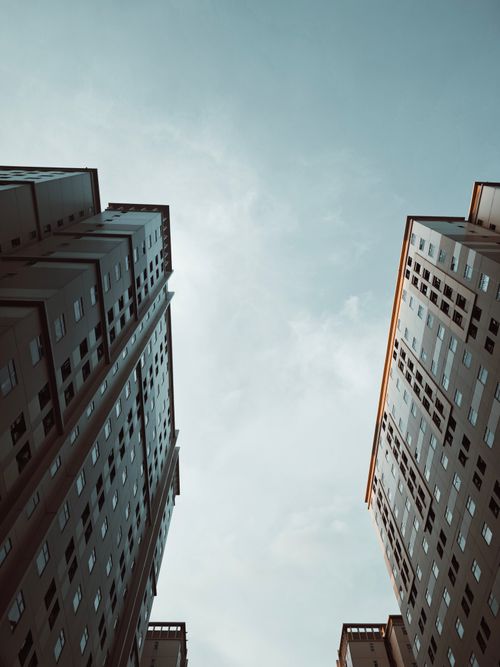 Free Upward view of skyscrapers against a clear sky, showcasing urban architecture. Stock Photo