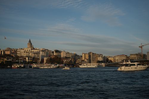 Free Stunning cityscape of Istanbul with Galata Tower and boats on the water at dusk. Stock Photo
