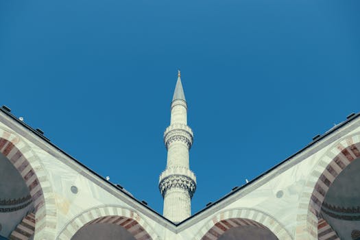 View from below of the Sultan Ahmet Mosque minaret with clear blue sky in İstanbul.