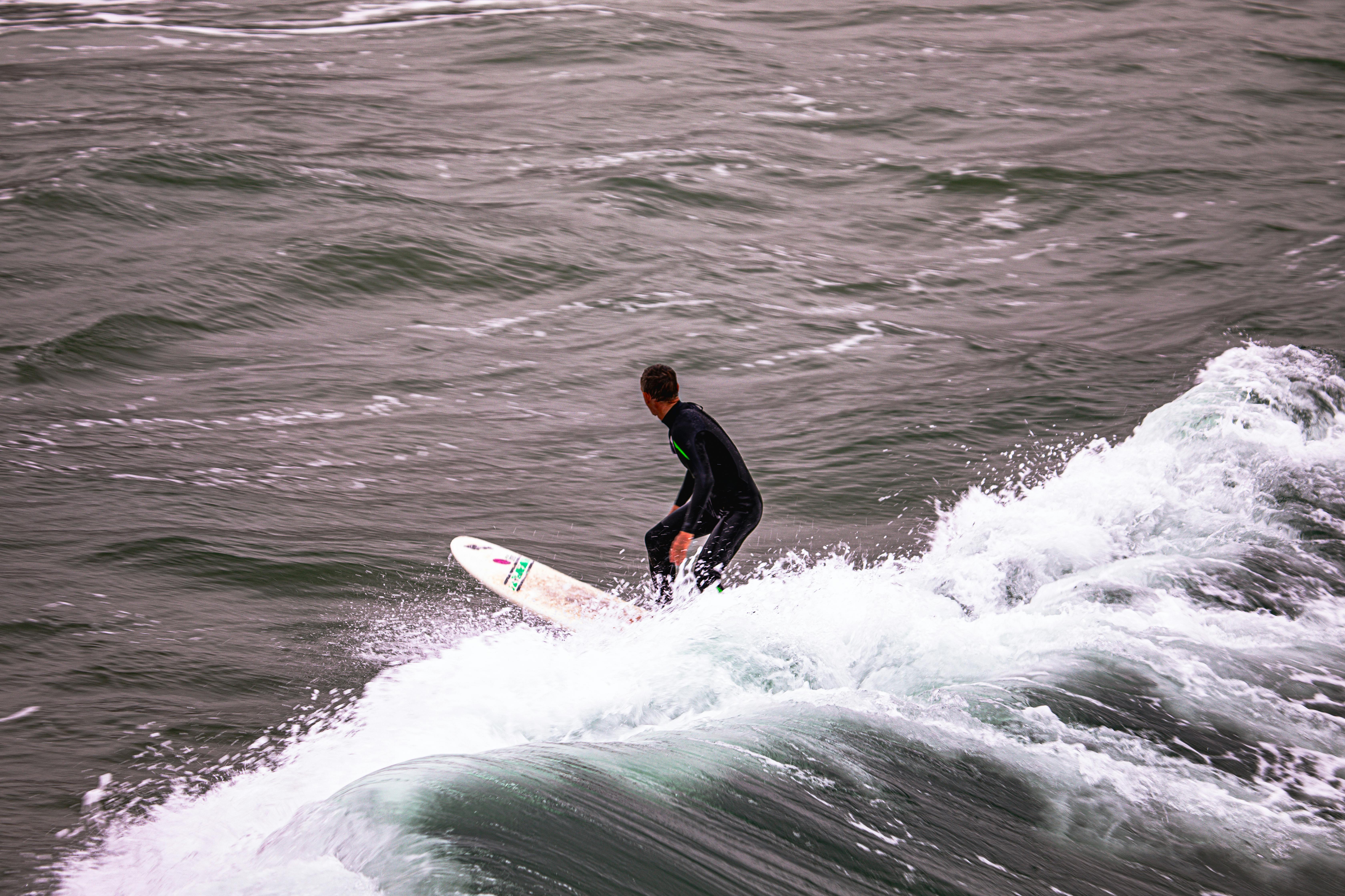 A surfer skillfully rides the waves off the coast of Bournemouth, England.