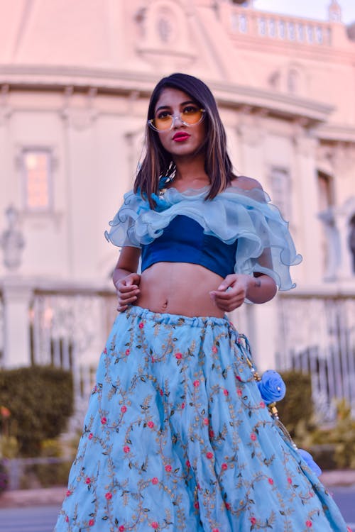 Woman Wearing Blue Crop Top and Floral Skirt