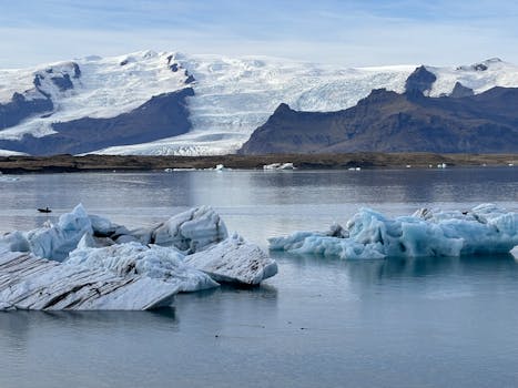 Stunning icy panorama of Jokulsarlon Glacier Lagoon in Iceland with floating icebergs and tranquil waters.