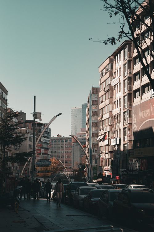 Free A busy urban street scene with modern buildings and pedestrians in a city setting. Stock Photo