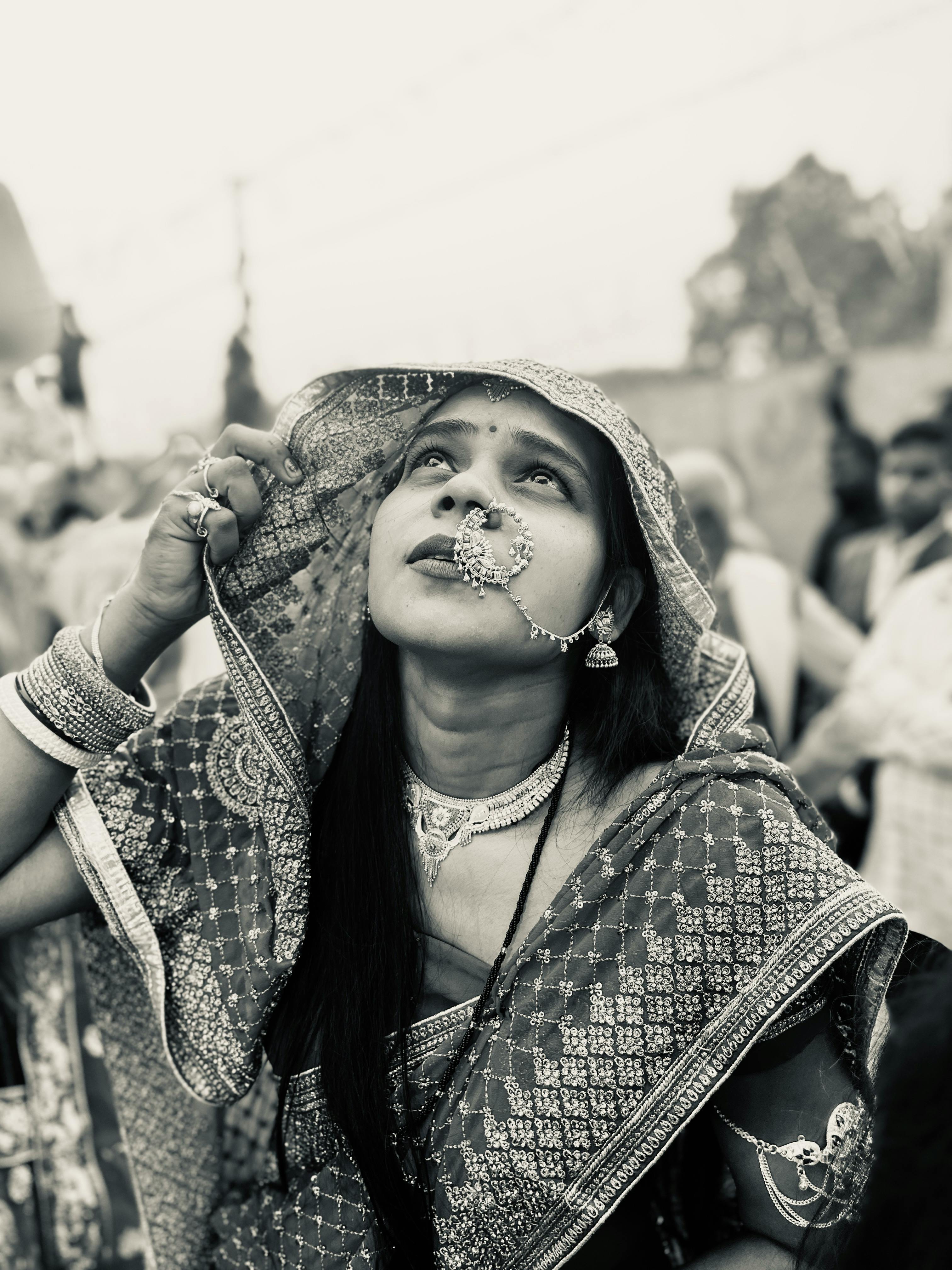 Free A South Asian woman in traditional attire gazes upwards during Chhath Puja festival in India. Stock Photo