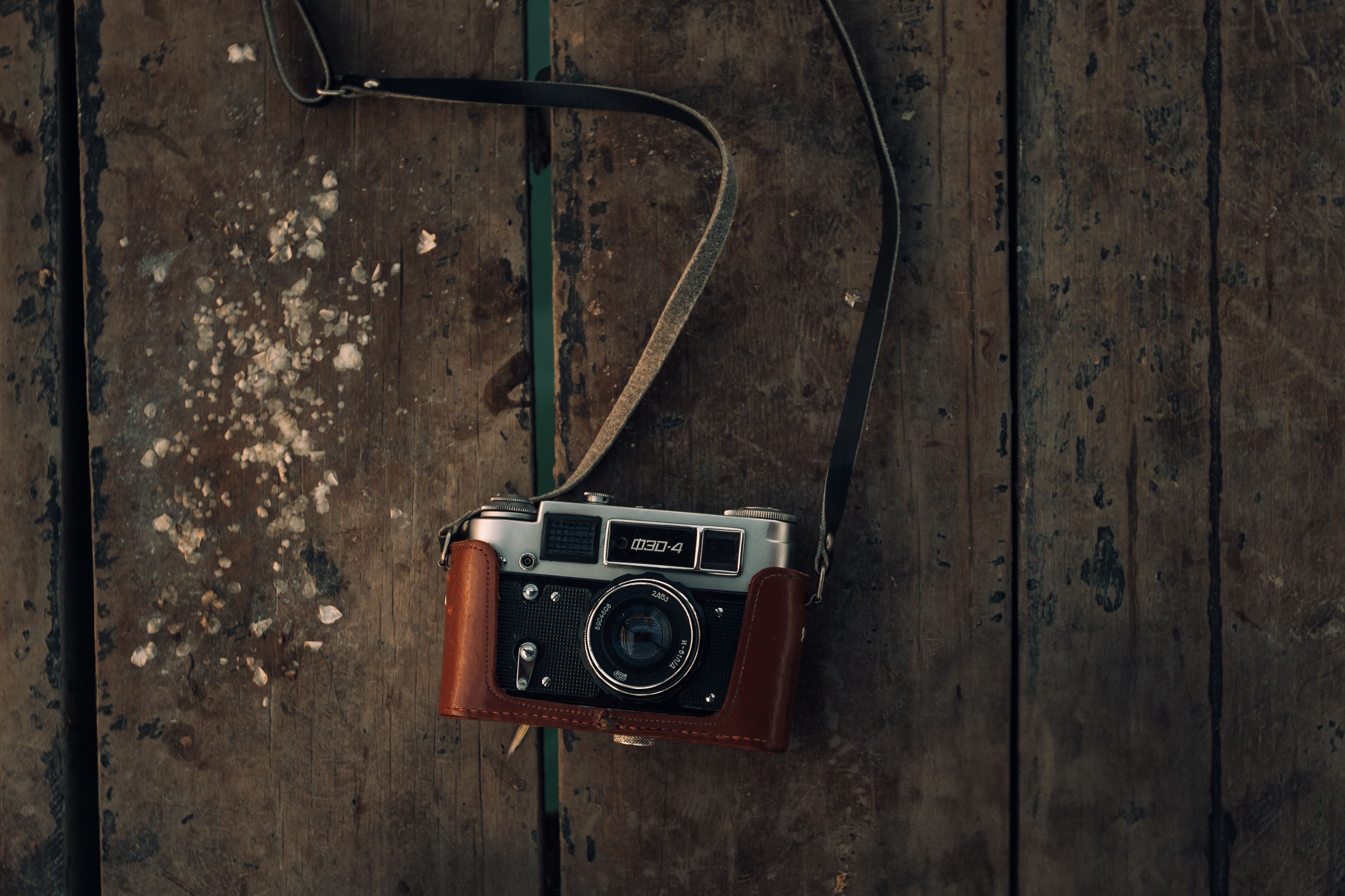 Classic film camera resting on weathered wood, capturing nostalgia.