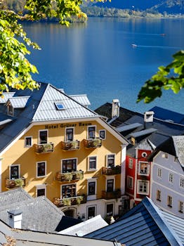 Charming autumn view of Hallstatt by a serene mountain lake in Austria.