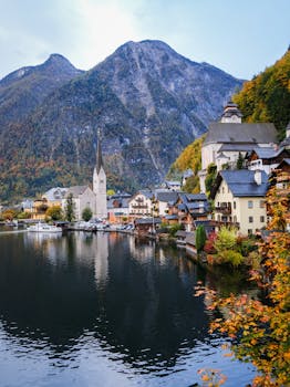 Discover the charming lakeside village of Hallstatt in autumn, featuring stunning traditional architecture and vibrant fall colors.