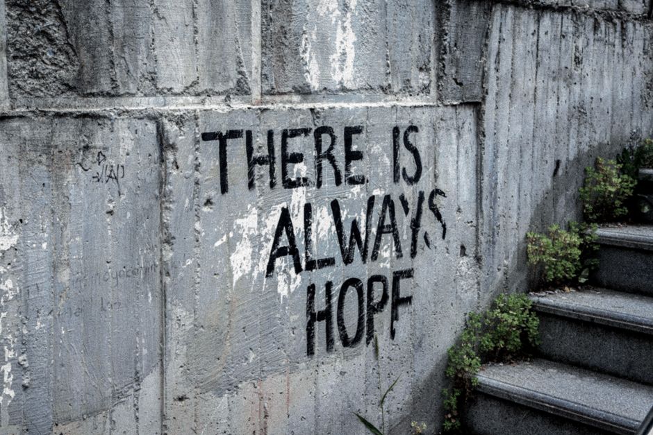 Graffiti on a wall reading 'there is always hope' — ibogaine is used for addiction and PTSD through autobiographical review; ayahuasca for trauma through symbolic visionary content