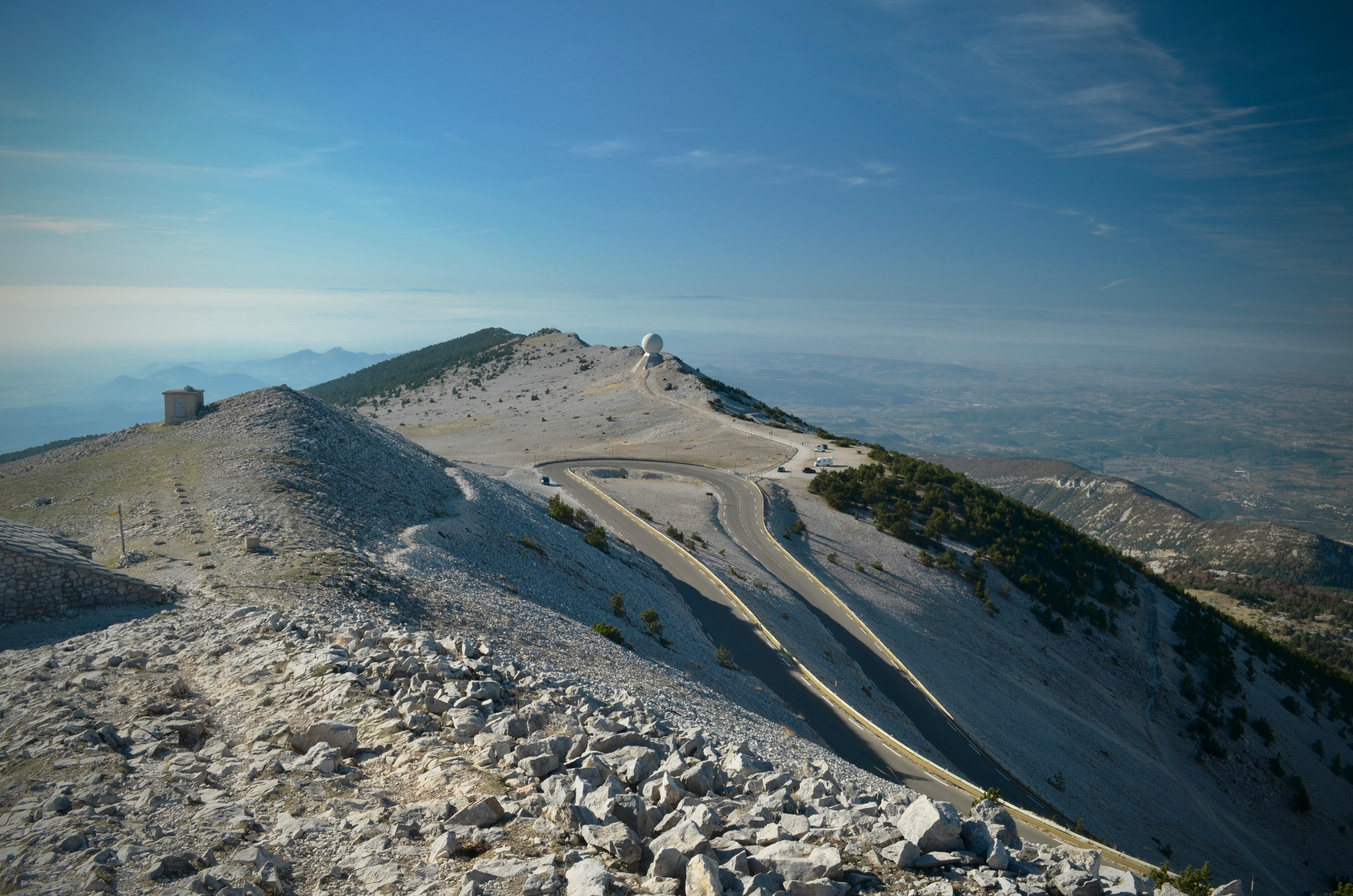 Breathtaking landscape of Mont Ventoux with winding road and clear sky, ideal for cycling and adventure.