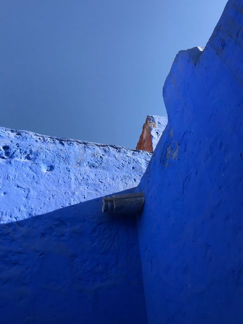 Architectural elements of vivid blue walls in Arequipa, Peru, showcasing unique textures and perspectives.