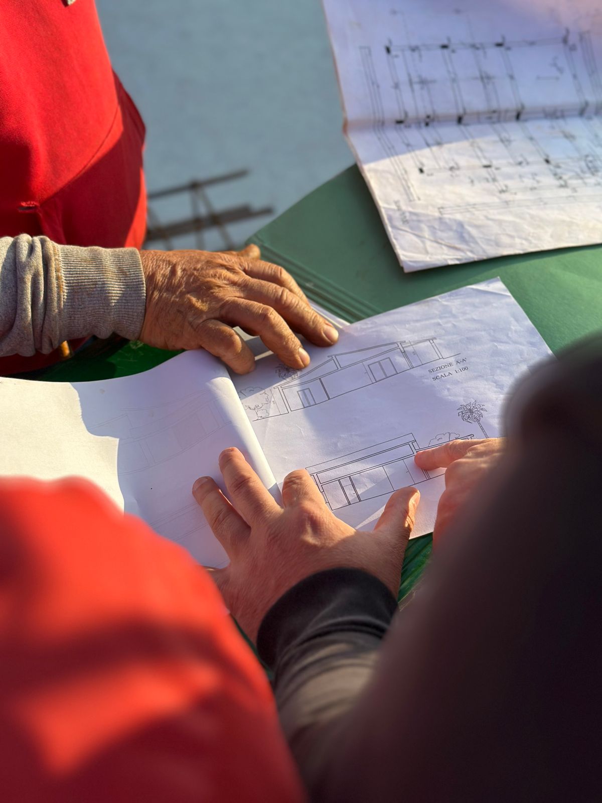 Engineers reviewing building code documents and blueprints