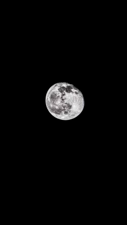 Free A clear and detailed photograph of the full moon set against a stark black sky. Stock Photo