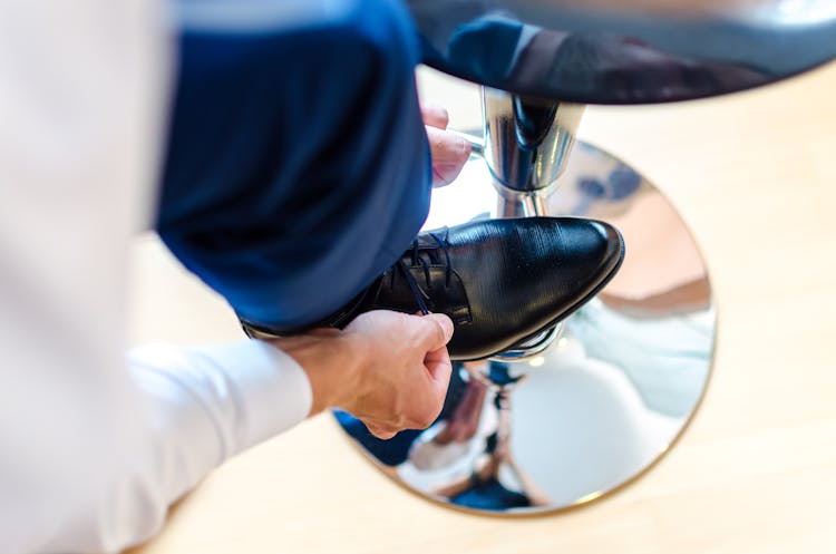 Person Lacing Up His Shoe