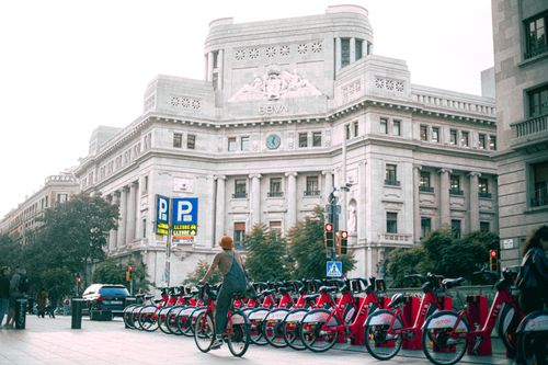 Free City street with bicycle rentals and iconic Barcelona architecture. Stock Photo