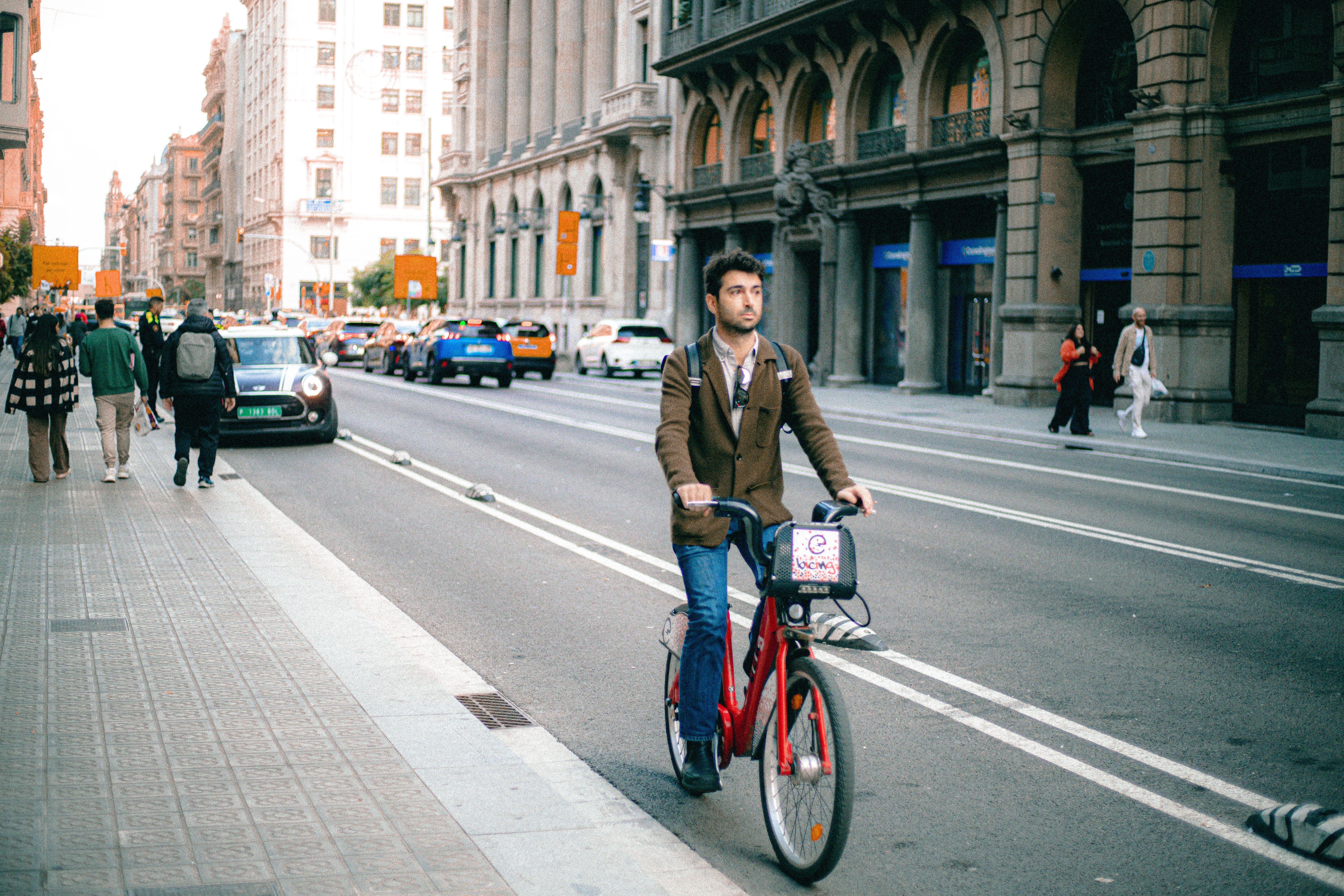 Urban Cycling in a Bustling Cityscape · Free Stock Photo