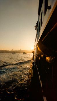 Capturing a serene sunset ferry ride with distant views of Istanbul's skyline.