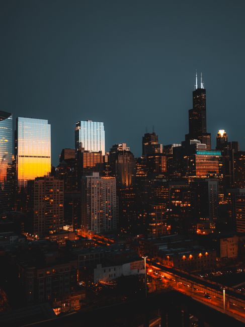 Stunning view of Chicago's illuminated skyline featuring the Willis Tower during twilight.