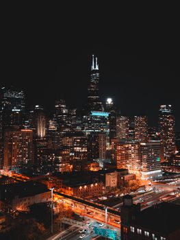Stunning night view of Chicago skyline with glowing city lights and high-rise buildings.