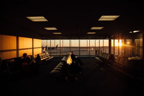 Free Peaceful airport waiting area with sunset silhouettes and quiet ambiance. Stock Photo