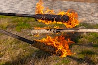 Burning Wooden Torches in Outdoor Setting