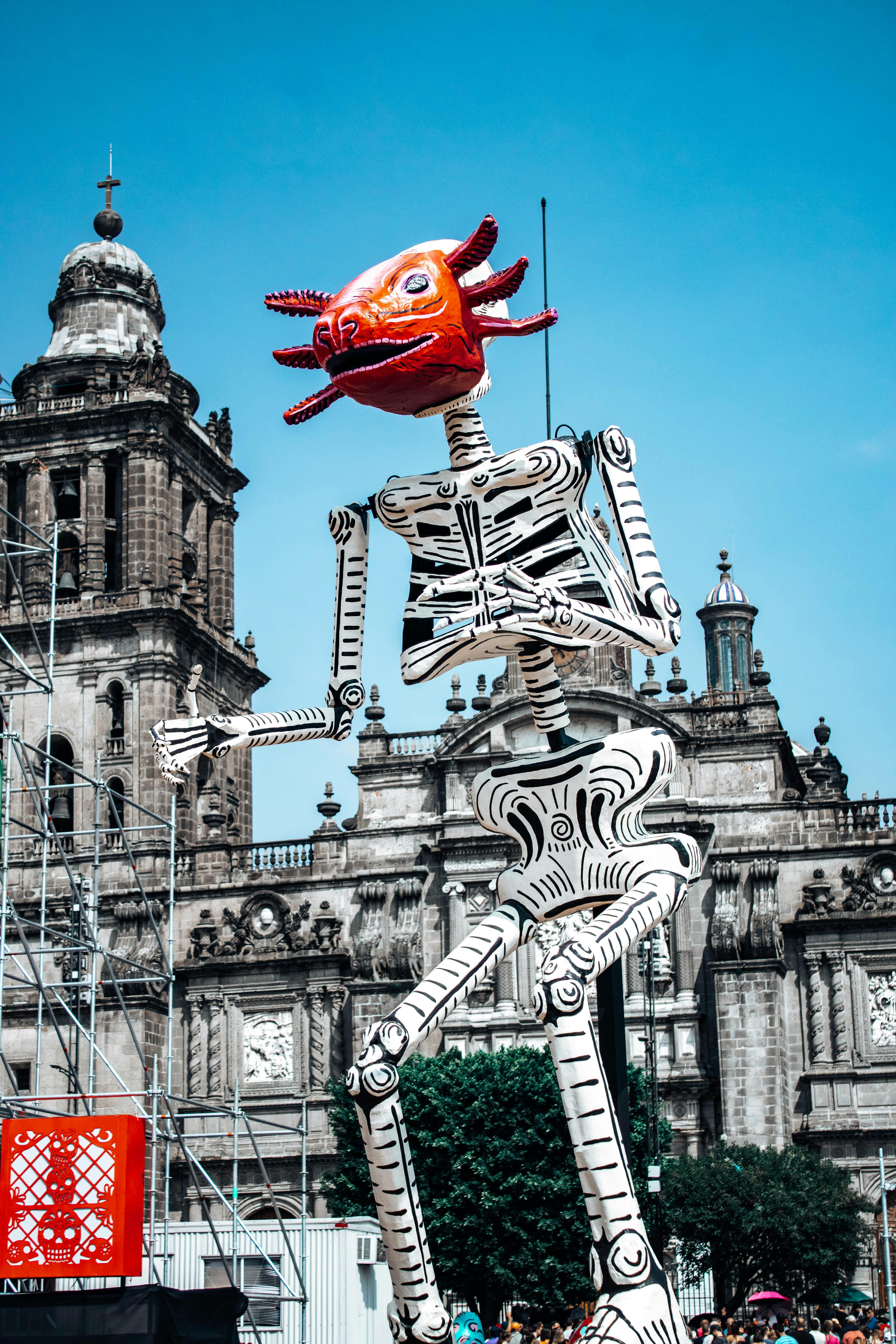 A vibrant Day of the Dead display featuring a giant skeleton in Mexico City's Zócalo.