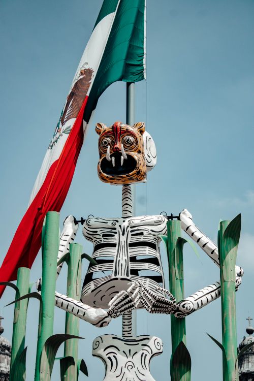 Free Skeleton sculpture with Mexico flag during Day of the Dead celebrations in CDMX, Mexico. Stock Photo