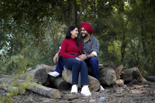 Free A couple enjoying a serene moment in a Himachal Pradesh forest setting. Stock Photo