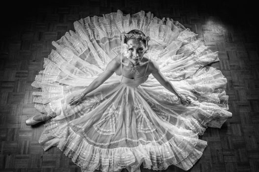 Ballet performance with intricate Catrina makeup and flowing dress, top view.