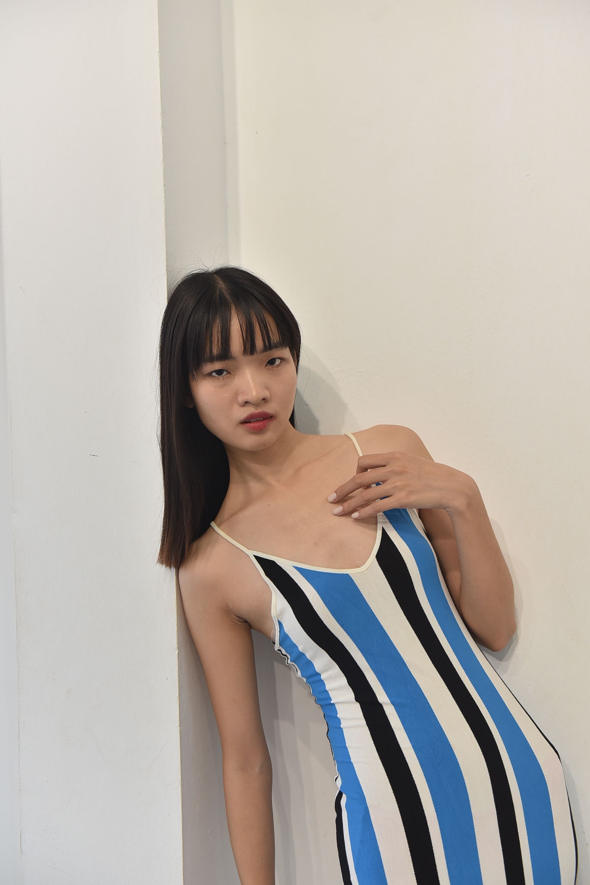Stylish Portrait of a Woman in Striped Dress · Free Stock Photo