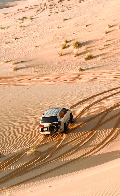 Free 4x4 vehicle on a thrilling desert safari in Abu Dhabi's Sweihan dunes. Stock Photo
