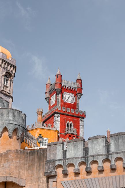 Colorful towers and turrets of Pena Palace against a blue sky