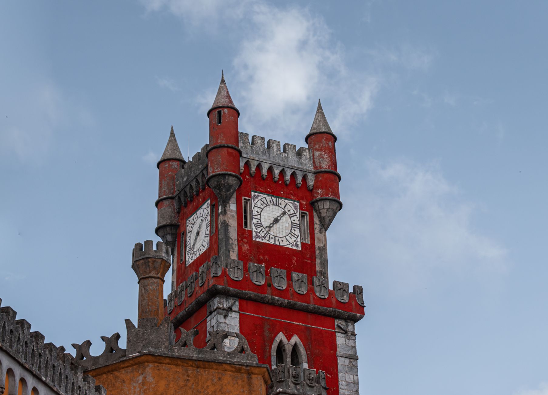 Colourful palace towers rising above wooded hills in Sintra