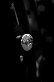 Elegant black and white close-up of a Rolls Royce interior detail, highlighting luxury.