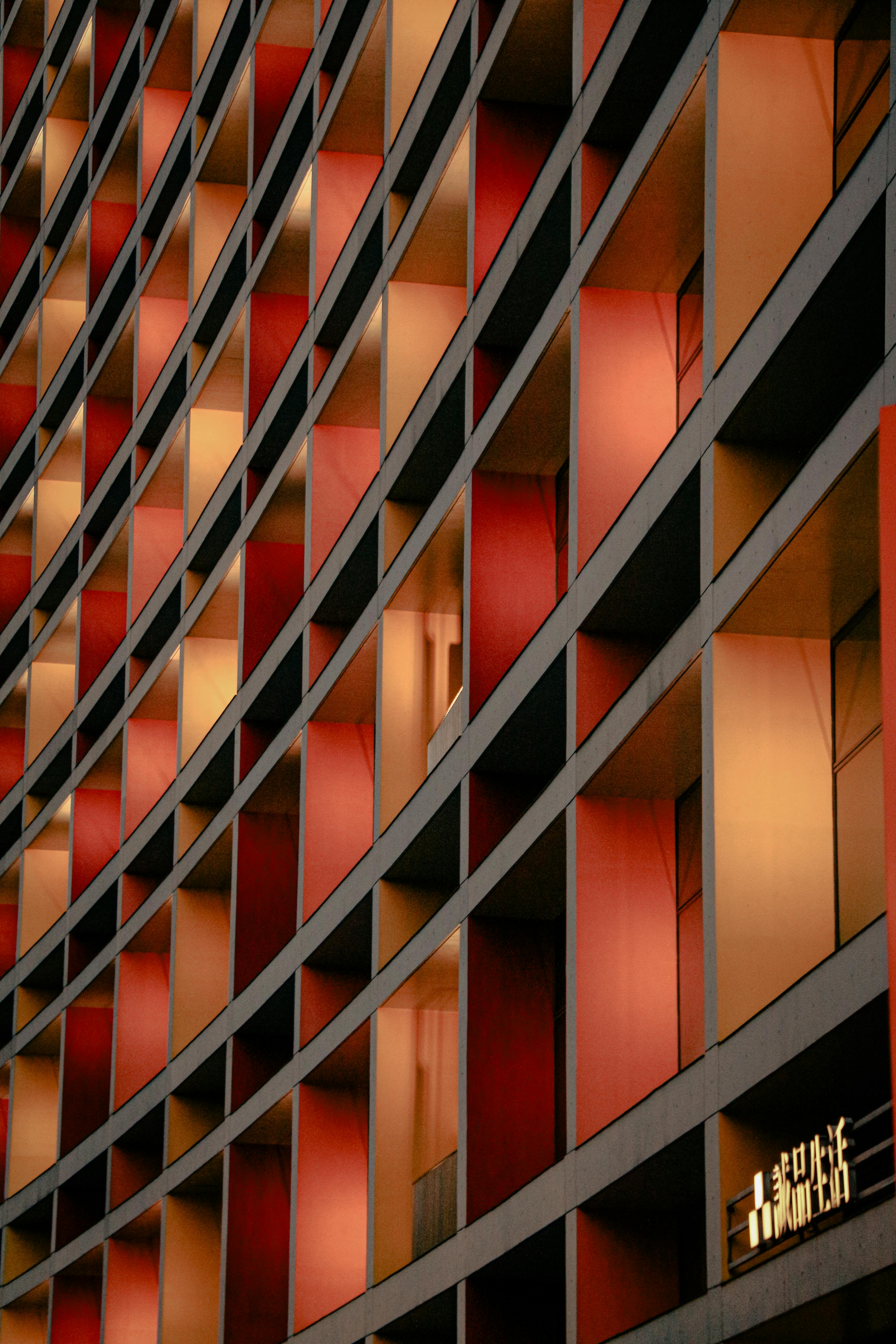 A striking facade in Taipei, featuring curved architectural lines and red-toned panels.