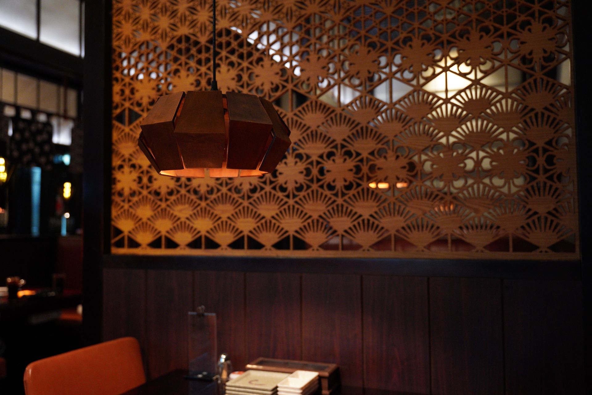 Stylish restaurant interior with elegant ambient pendant lighting at night