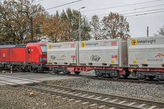 Freight train with Innofreight containers on tracks during autumn.