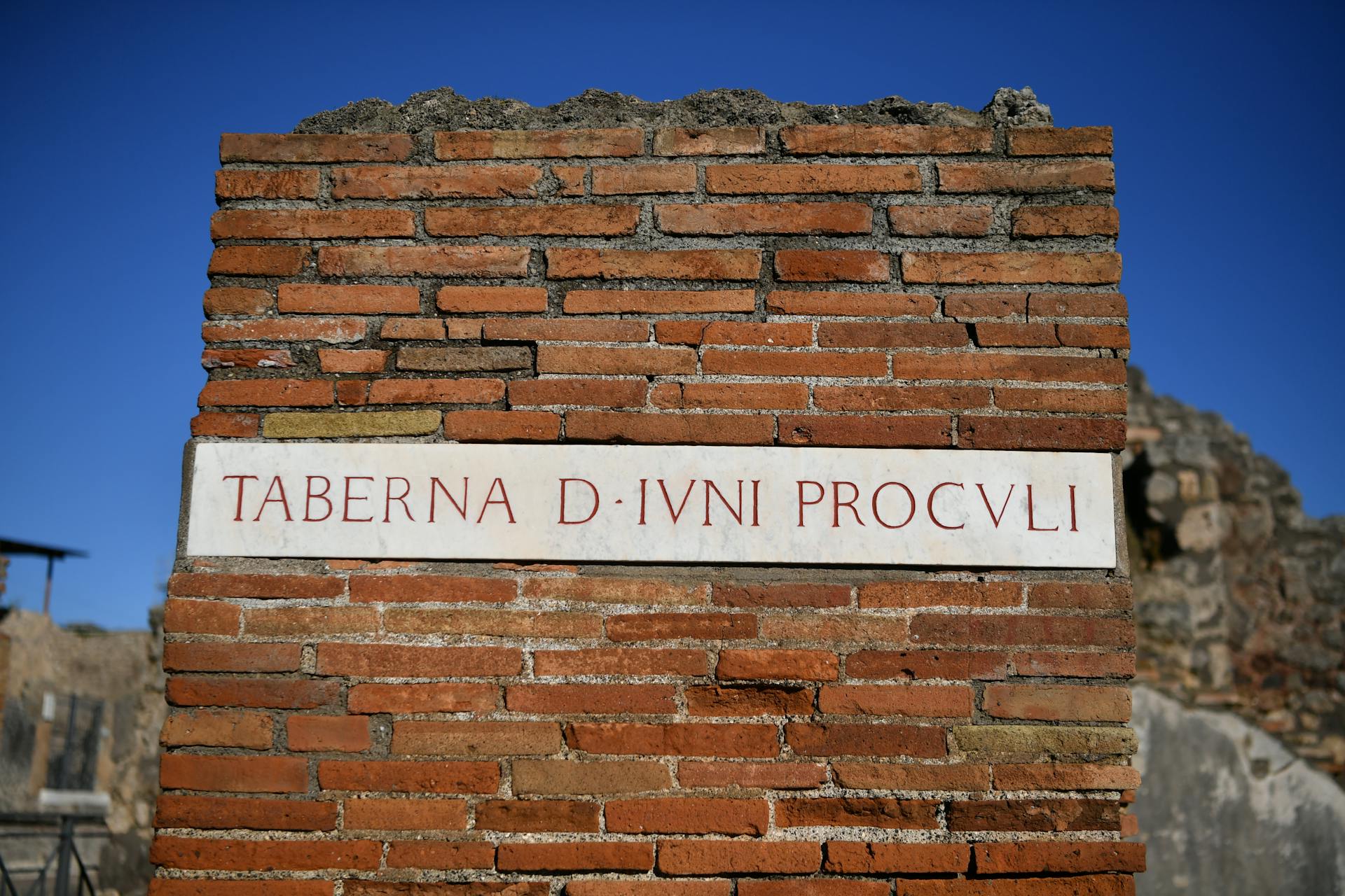 Close-up of ancient Roman brick sign at the ruins of Pompeii, Italy.