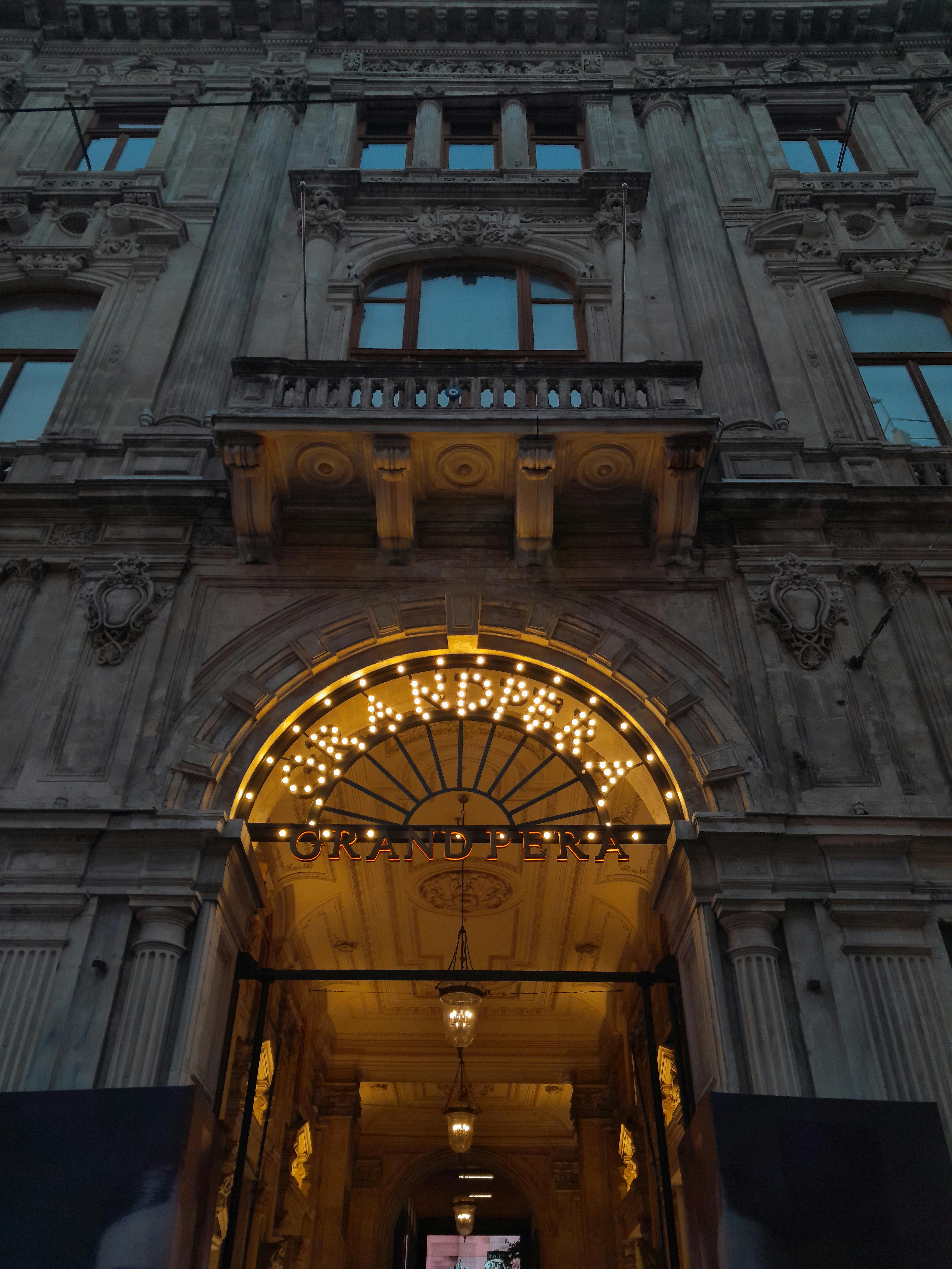 Grand Pera Entrance with Illuminated Sign · Free Stock Photo