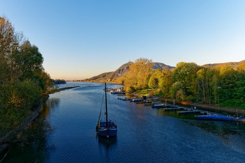 Free Tranquil scene of a boat on the Rhine River in Bad Honnef, Germany during sunset. Stock Photo