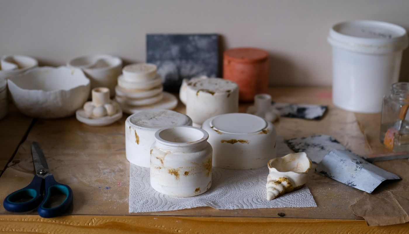 Ceramic prototypes and tools on a studio workbench — photo by Cem Nisan on Pexels