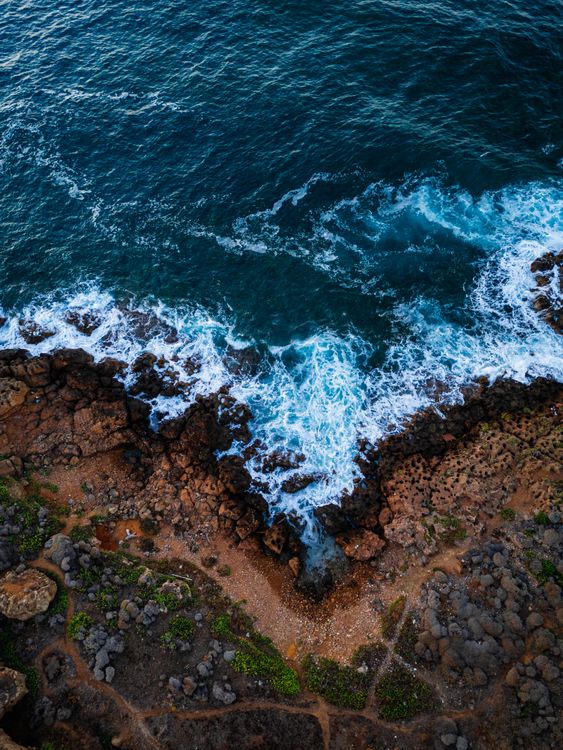 Aerial View of Rocky Coastline and Ocean Waves · Free Stock Photo
