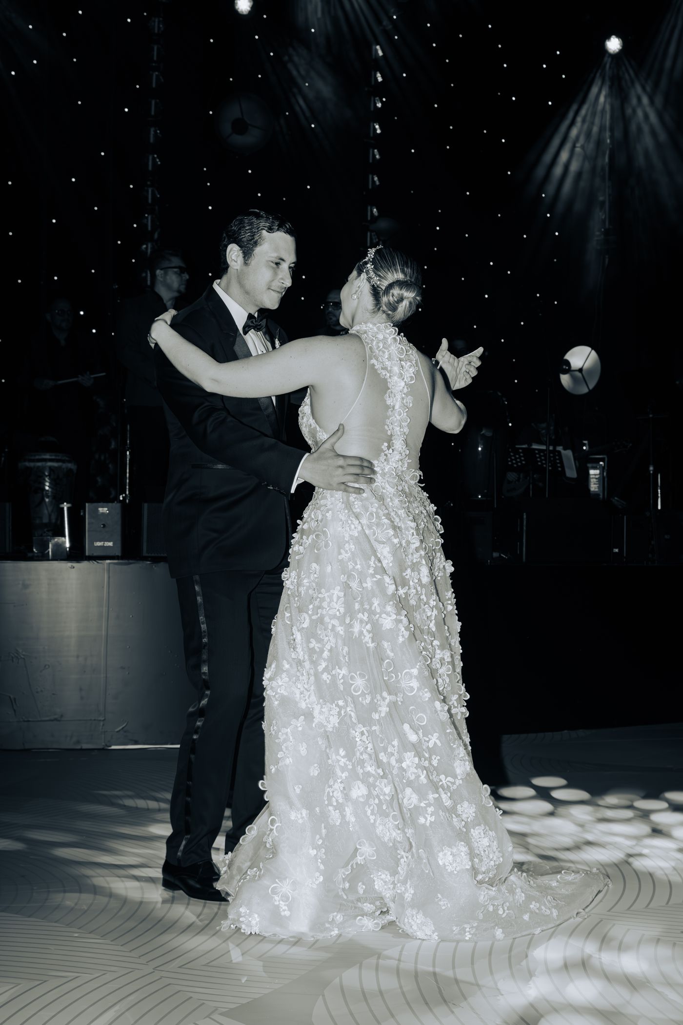 Wedding couple dancing under shimmering lights