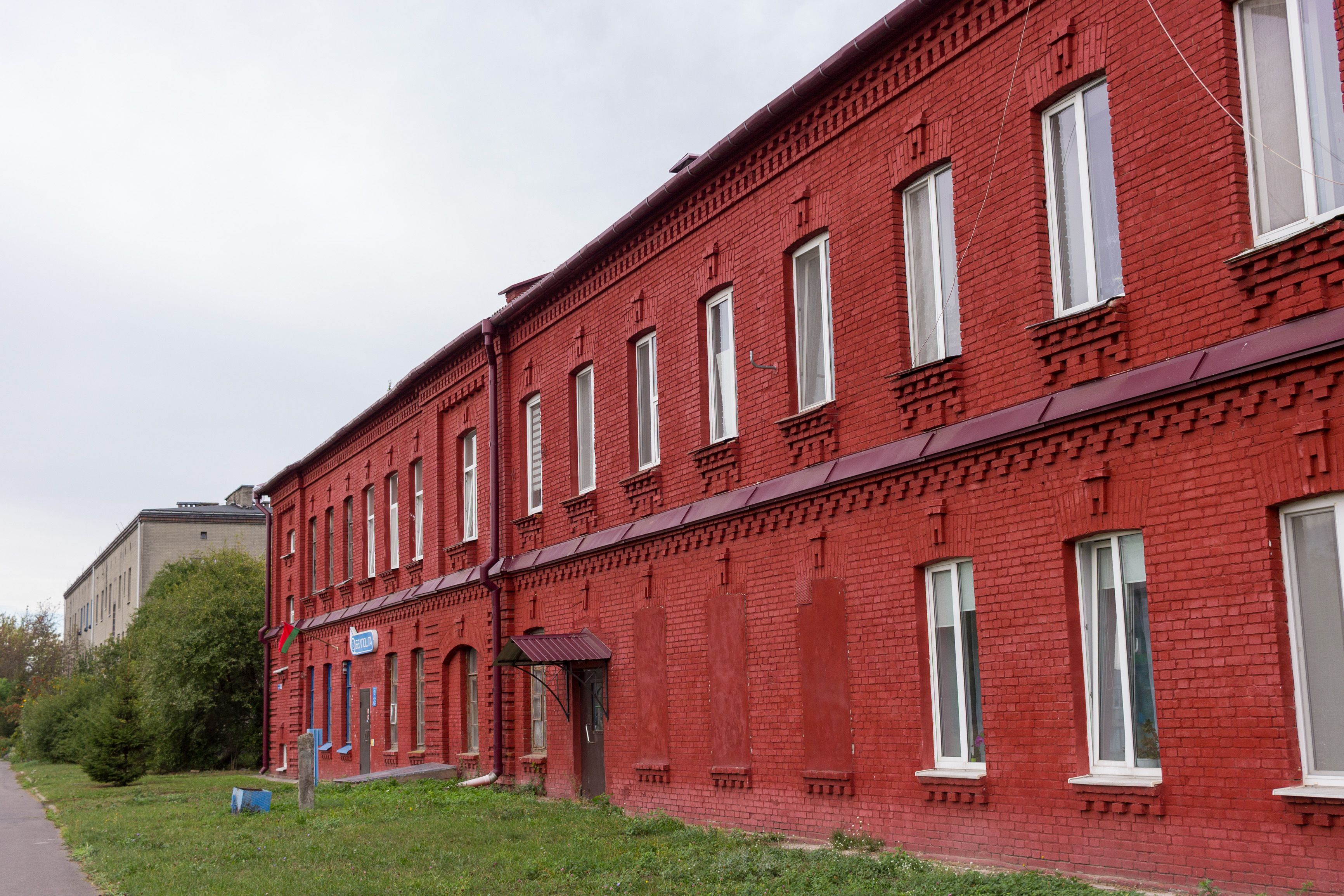 Historic Red Brick Building Exterior on Cloudy Day · Free Stock Photo