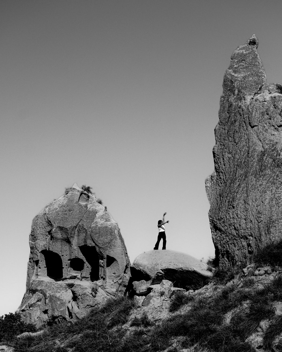 Person Posing on Rugged Rock Formation · Free Stock Photo