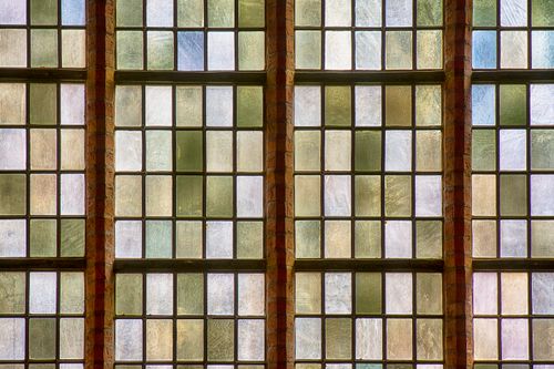 Free Close-up view of vintage stained glass windows in a church, showcasing intricate patterns. Stock Photo