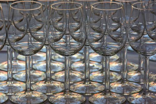 Free Artistic arrangement of empty wine glasses creating a kaleidoscope effect. Stock Photo