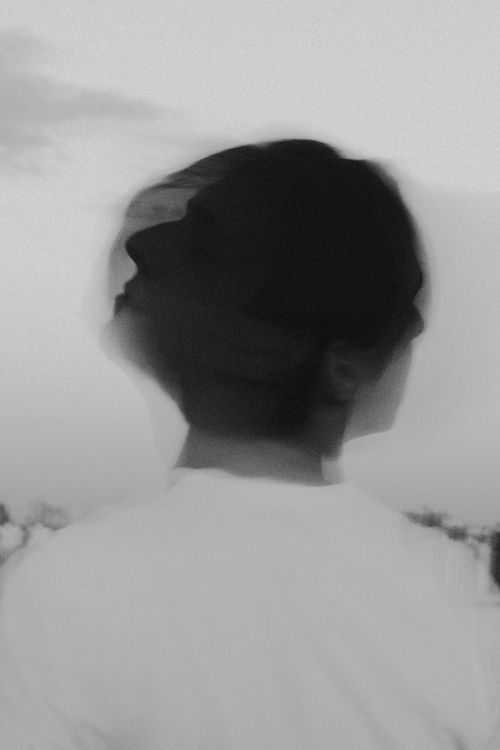 Free Artistic black and white portrait of a person with a blurred motion effect, creating a conceptual and dreamy look. Stock Photo